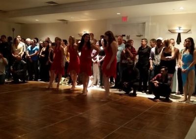 observers watch four dancers on a dance floor