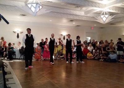 observers watch four dancers on a dance floor