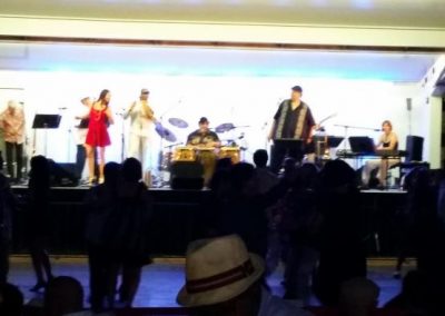 band plays music on stage while people dance