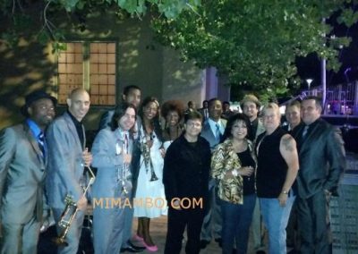 group of people and trumpeters posing for photo