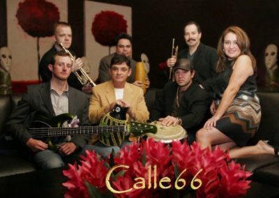 Photo of band sitting on couch with their instruments. Text at bottom reads"Calle66"