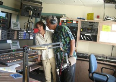 a man and woman singing into big microphone