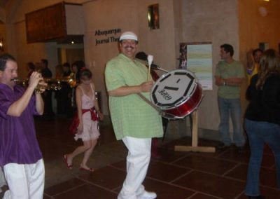 man holding and playing drum