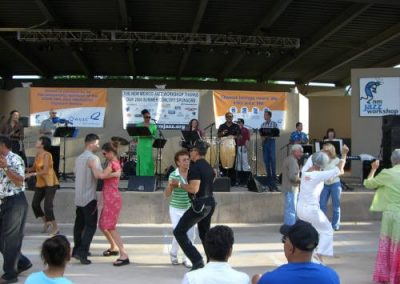 band plays music on stage while people dance