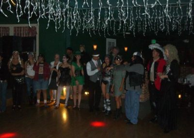 group of people standing around empty dance floor