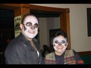 two people posing for photo. Both have skeleton face paint
