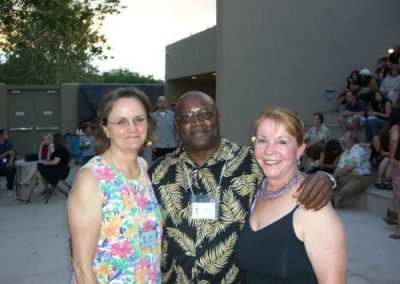 Group of three posing for picture